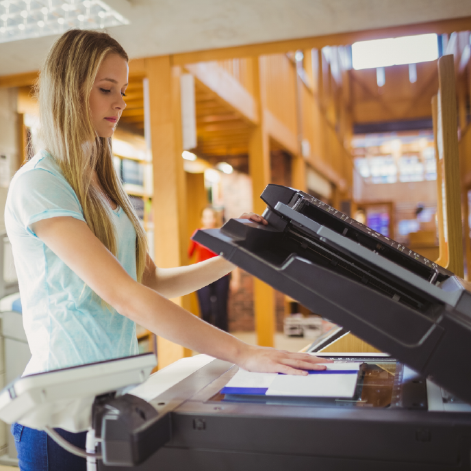 A student using a copier in the library.